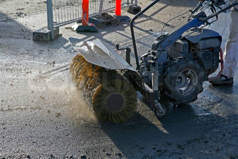 Worker cleaning up at a construction site, stock photo