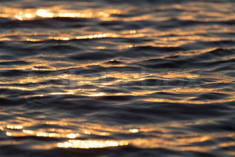 Seamless texture warm color shining sunset water surface, stock photo