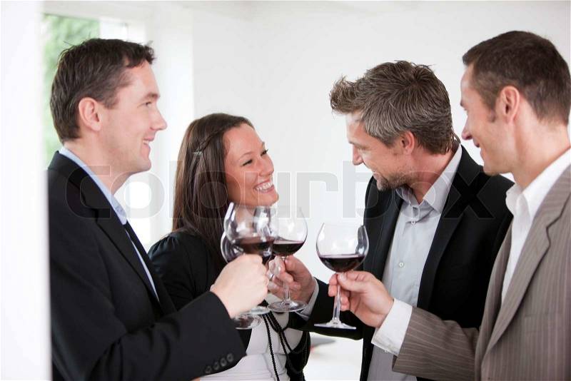 A group of friends enjoying red wine, stock photo