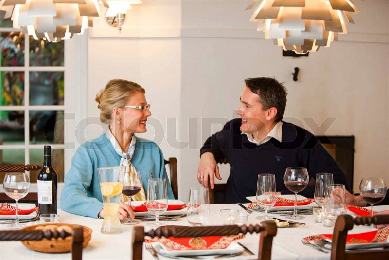 A european couple enjoying conversation during a dinner party, stock photo