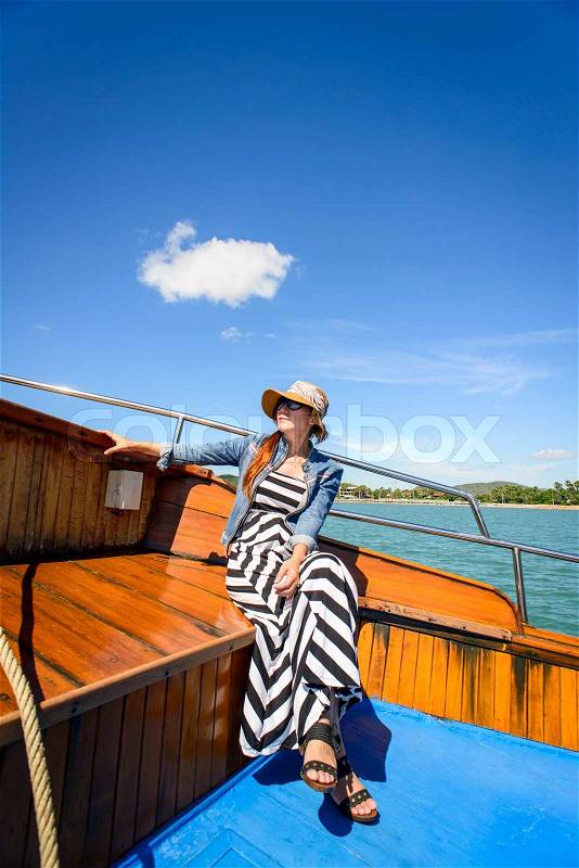 Asian woman relaxing on cruise with sunny day, stock photo