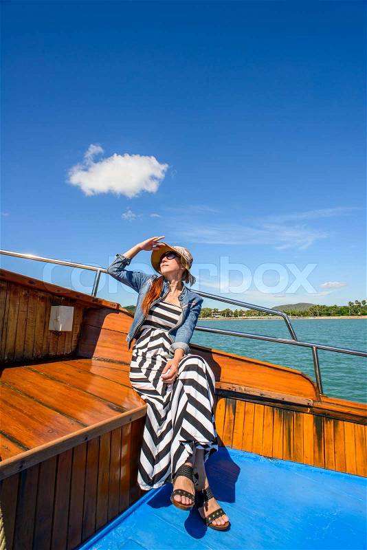 Asian woman relaxing on cruise with sunny day, stock photo