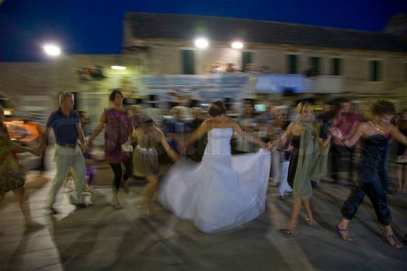 Happy people gathered to Croatian wedding - dancing after the ceremony, stock photo
