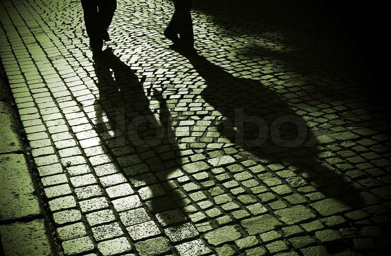 Two men walking home through the old silent Goslar alleys, stock photo