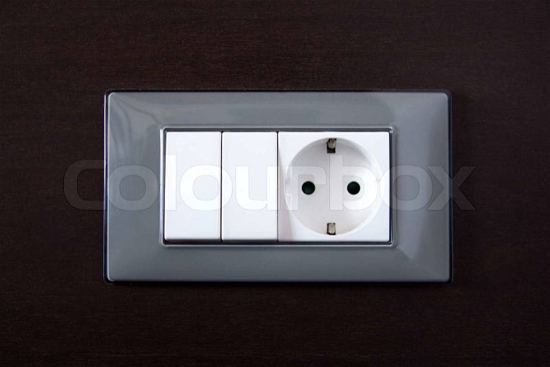 Wooden wall with power outlet and light switch, stock photo