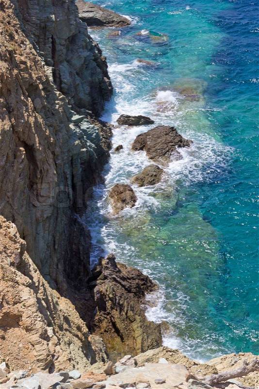 Rocky cliff and sea waves on Crete island, Greece, stock photo