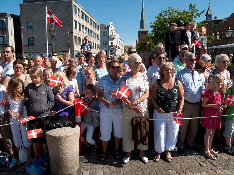 Waiting spectators to the official visit of Queen Margrethe the IInd to Nyborg, Denmark, stock photo