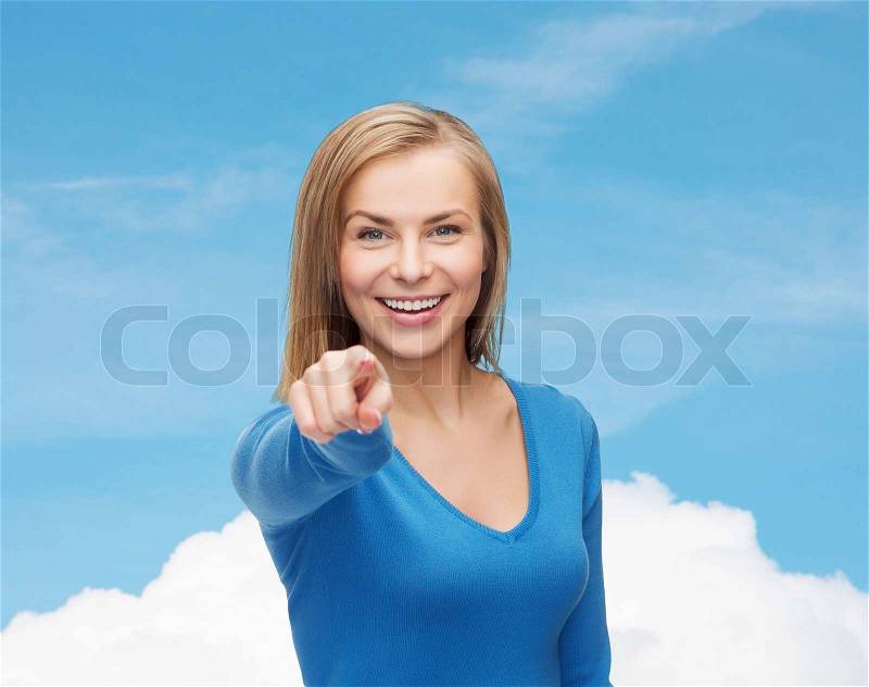 Gesture and people concept - smiling student pointing finger at you, stock photo