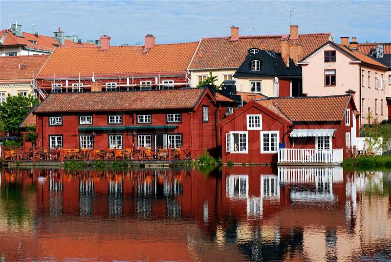 Colourful scandinavian houses by the river in Eskilstuna, Sweden, stock photo