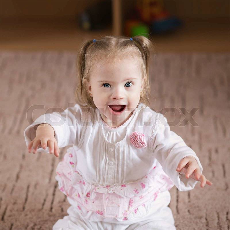 Little positive girl with Down syndrome, stock photo