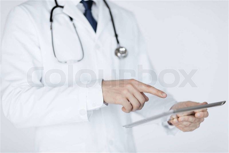 Close up of male doctor holding tablet pc, stock photo