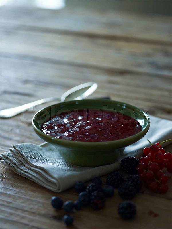 Bowl of mix berries porridge for breakfast, stock photo