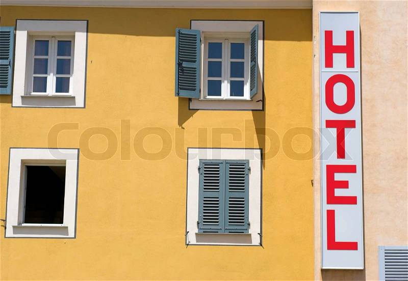 Hotel sign on hotel yellow wall, stock photo