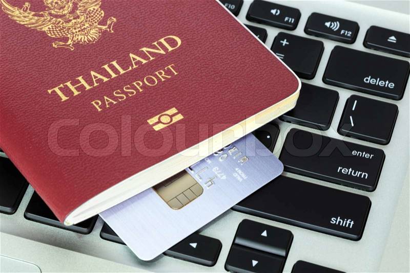Passport and credit card on keyboard concept electronic online booking, stock photo