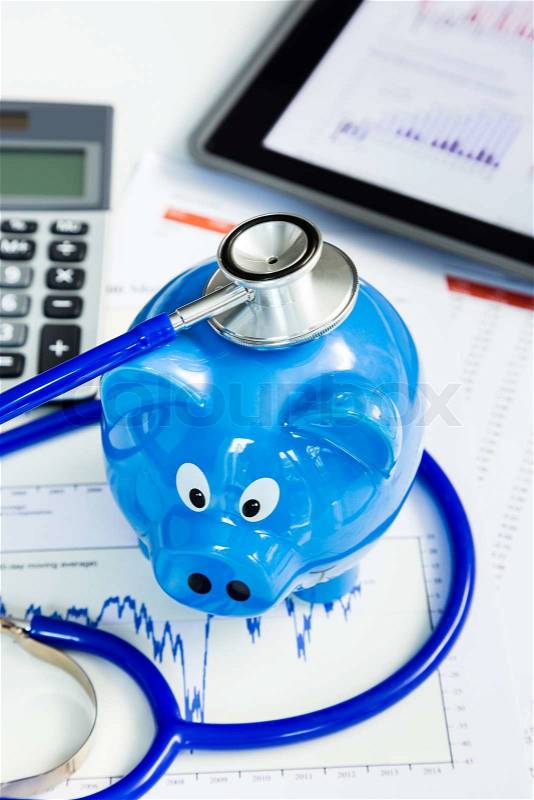 Stethoscope and piggy bank for financial health check concept, stock photo