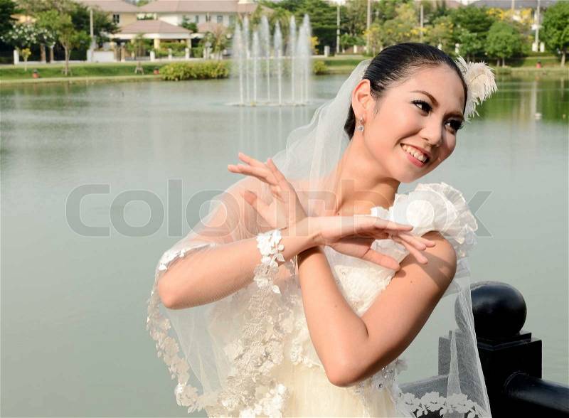 Beautiful girl in white gown of the bride dance, stock photo