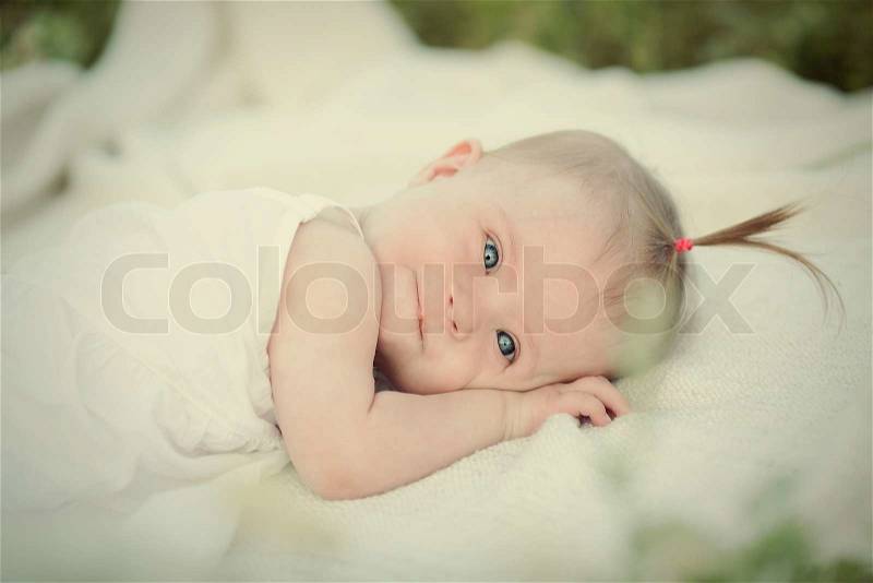 Little girls have Down syndrome rest on the nature, stock photo