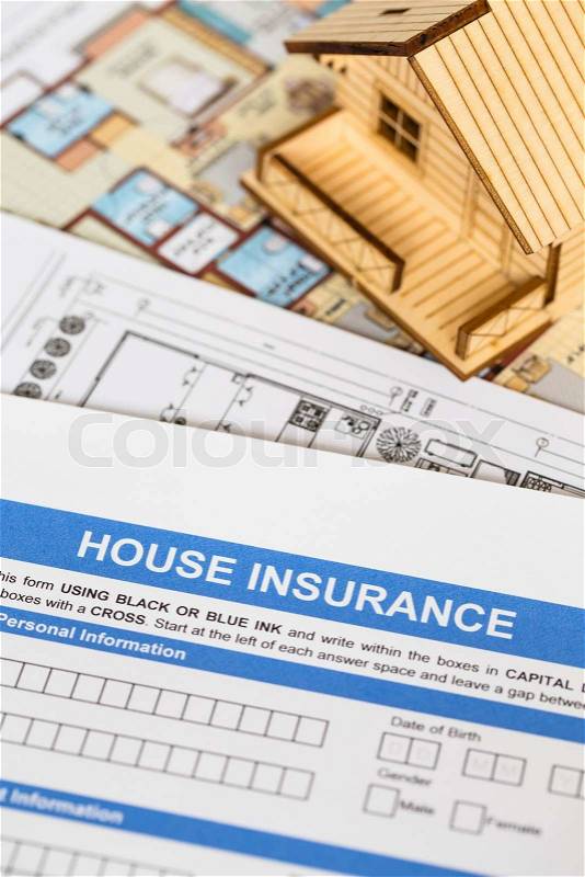 House insurance application with model house and construction plan, stock photo