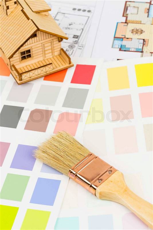 Paint color sample catalog with brush, drawing, and house model, stock photo