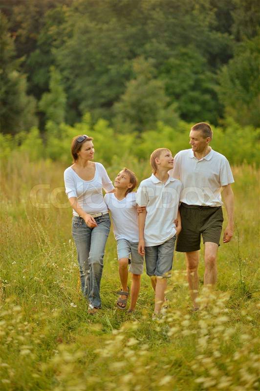 Happy cute Family walking in summer forest, stock photo