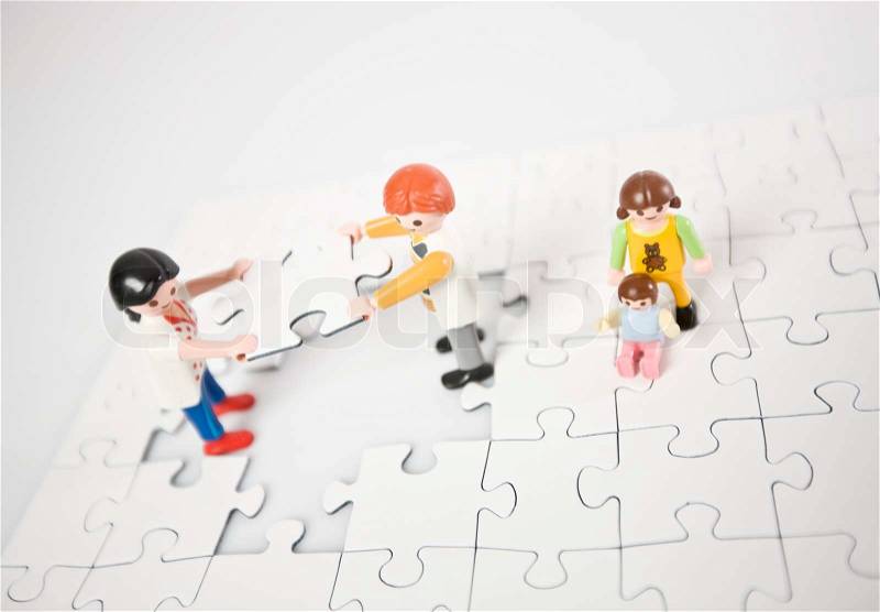 Concept of a family solving a puzzle together, stock photo