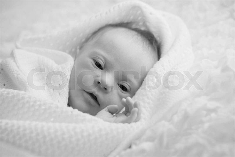 Newborn with Down syndrome is quiet and looks, stock photo
