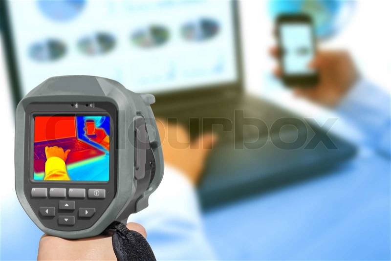Recording With Infrared Thermal Camera heat and radiation of Notebook and smartphones in the office, stock photo