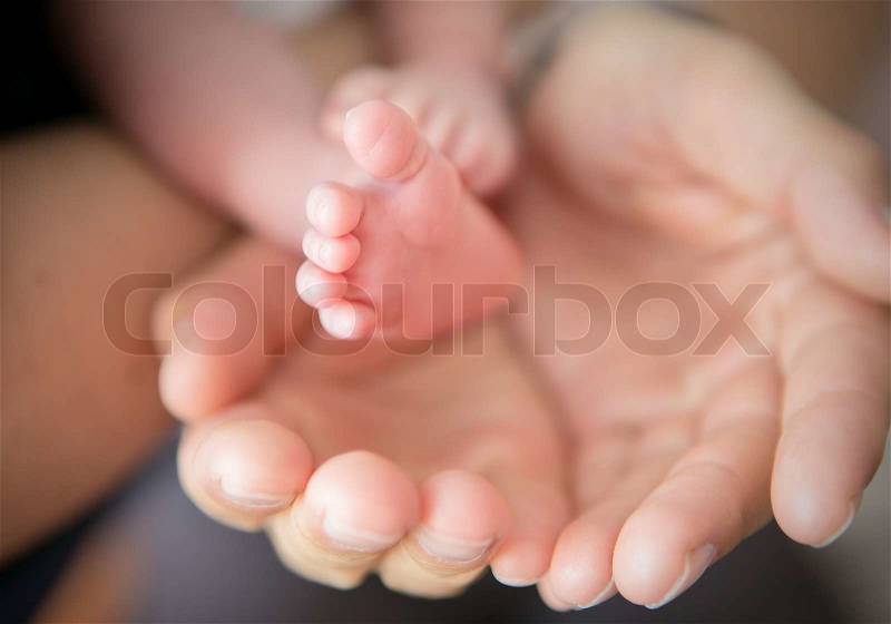 Little feet in Daddy\'s hands, stock photo
