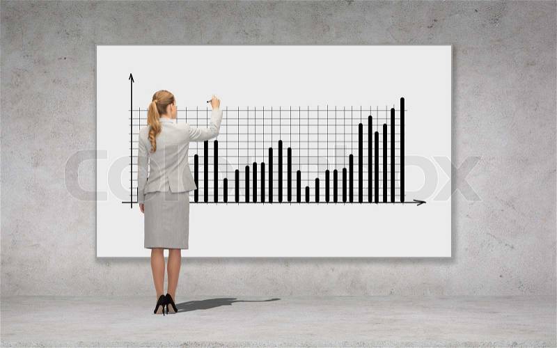 Business, development and office people concept - businesswoman with marker drawing chart over concrete wall background from back, stock photo