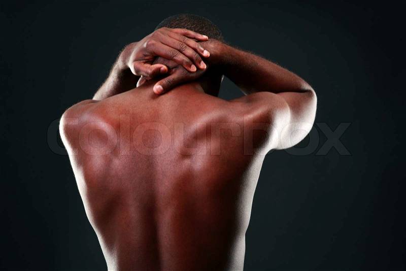 Back view portrait of a african man over black background, stock photo