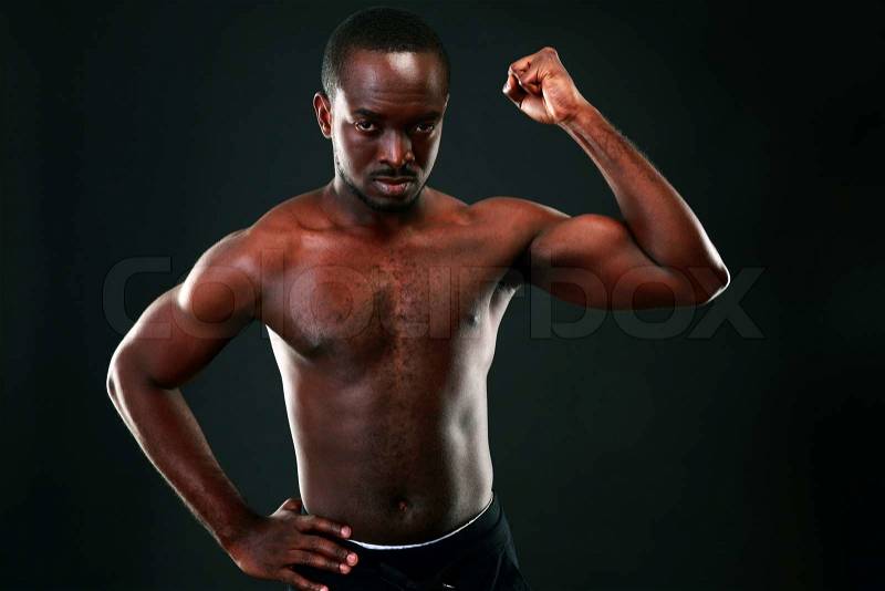 Strong young man showing his muscular , stock photo