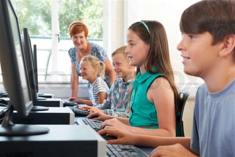 Group Of Elementary Pupils In Computer Class With Teacher, stock photo