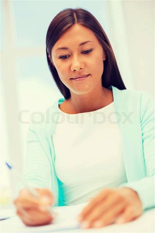 Education, school and business concept - international student studying in college, stock photo