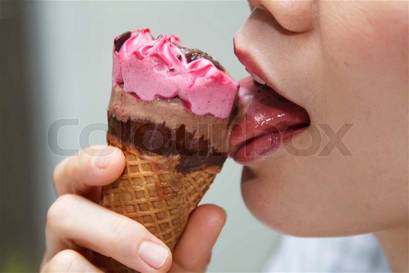 Asian girl eating ice cream happily, stock photo