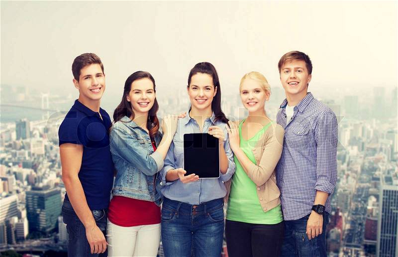 Education and modern technology concept - smiling students showing blank tablet pc computer screen, stock photo