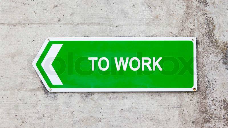 Green sign on a concrete wall - To work, stock photo