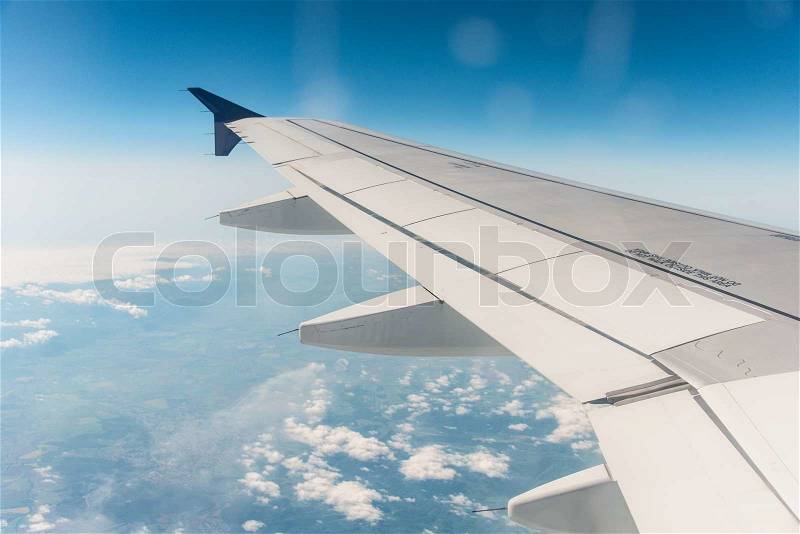 Airplane wing out of window, stock photo