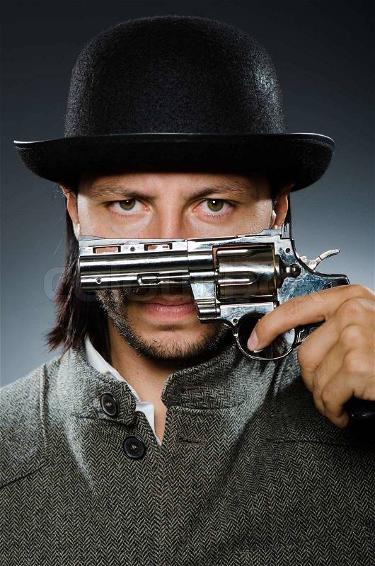Man with gun and vintage hat, stock photo