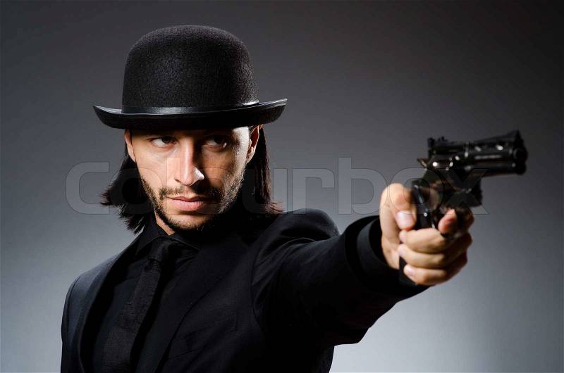 Man with gun and vintage hat, stock photo