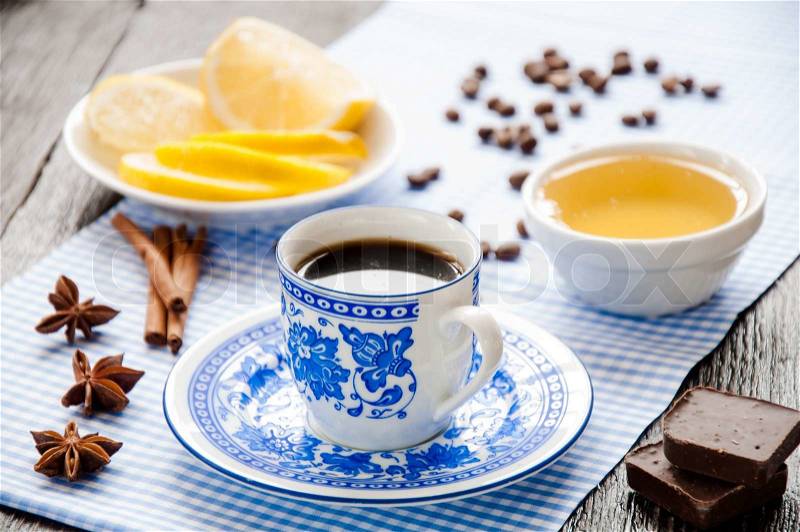 Espresso in blue cup with lemon and honey on table , stock photo