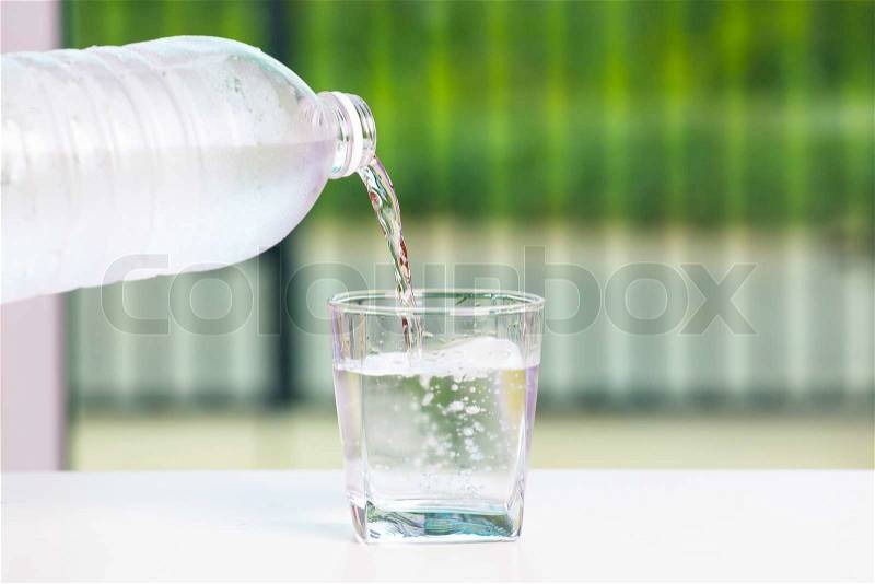 Pouring water on glass , stock photo