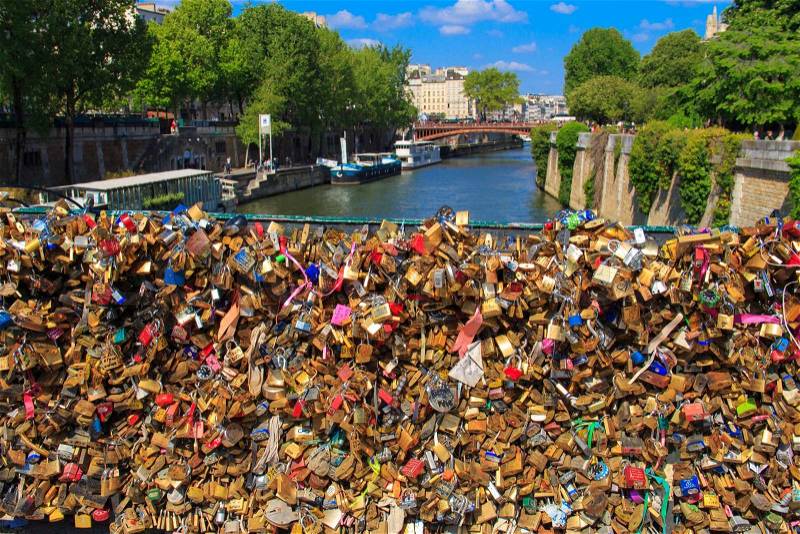PARIS, FRANCE - Mai 3, 2014: locks on the railing of the bridge over the Seine, the lovers as a sign of loyalty to leave the locks on the railing of the bridge, stock photo