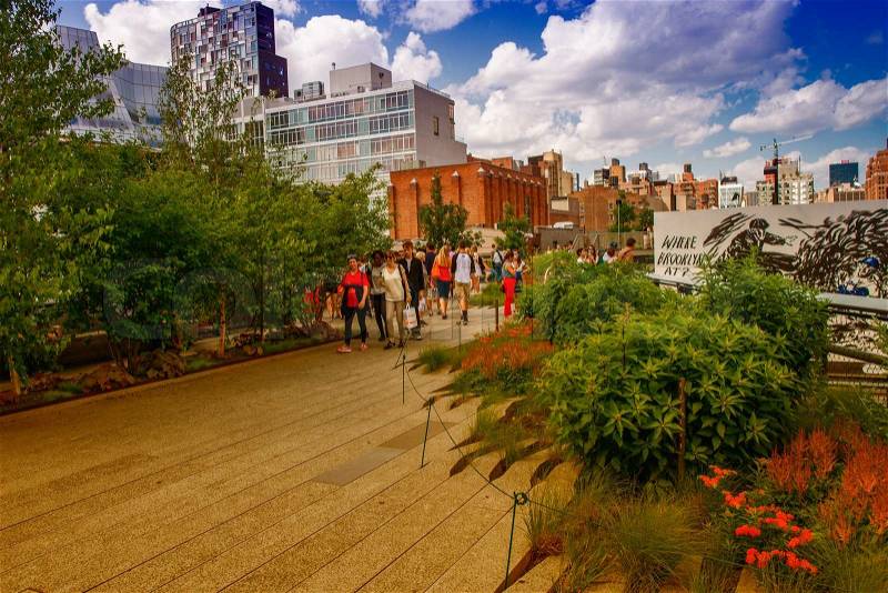 NEW YORK - JUNE 15, 2013: The High Line Park in New York with locals and tourists. The High Line is a popular linear park built on the elevated train tracks above Tenth Ave in New York City, stock photo