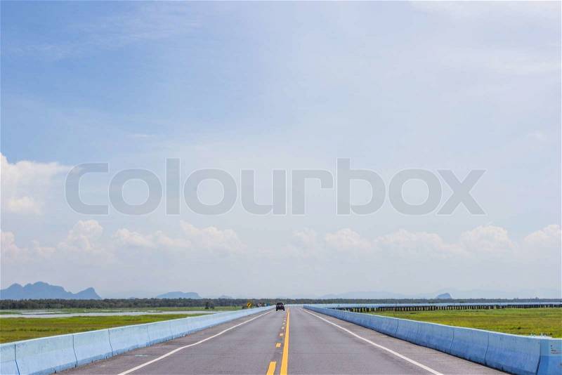 Running cars on the road with blue sky, stock photo