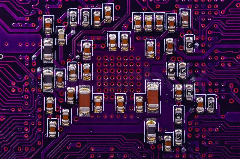 Microchips integrated on circuit board, close up, stock photo