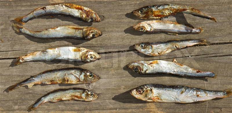 Plenty of small dried fishes on a stack, stock photo