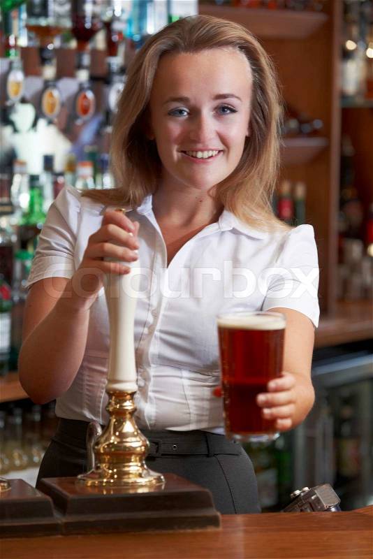 Female Bartender Serving Drink To Customer, stock photo