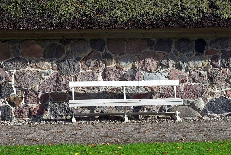 White Park Bench outside old cottage in Denmark, stock photo