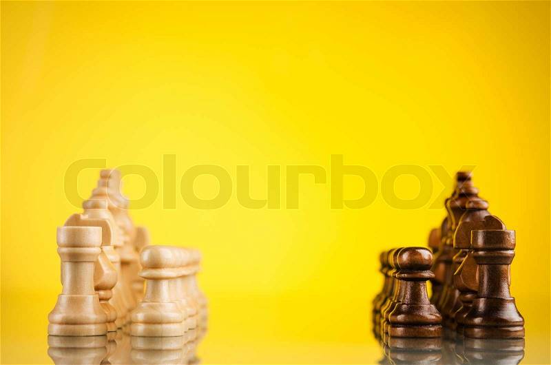 Opposition of black and white pieces in chess game, stock photo