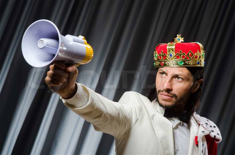 King with loudspeaker in funny concept, stock photo